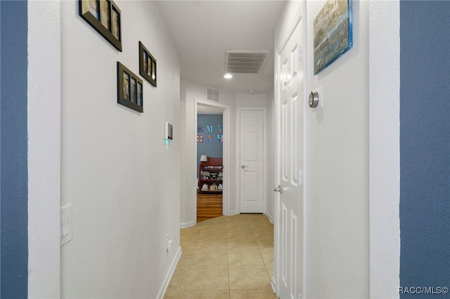 hall with light tile patterned floors