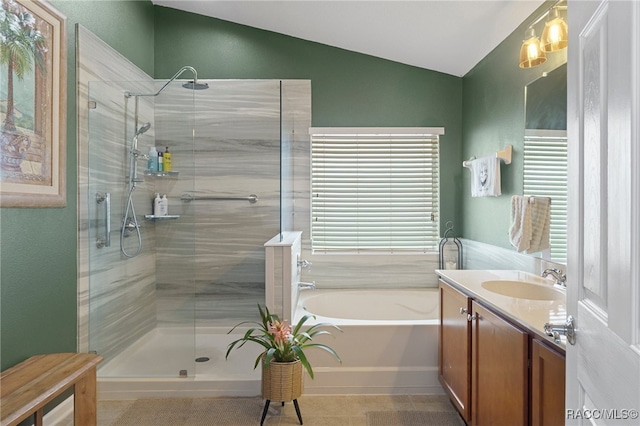 bathroom with vanity, independent shower and bath, and lofted ceiling