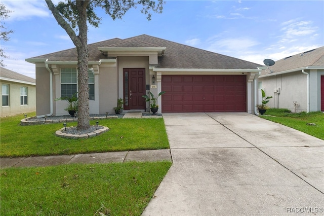 ranch-style house with a garage and a front lawn