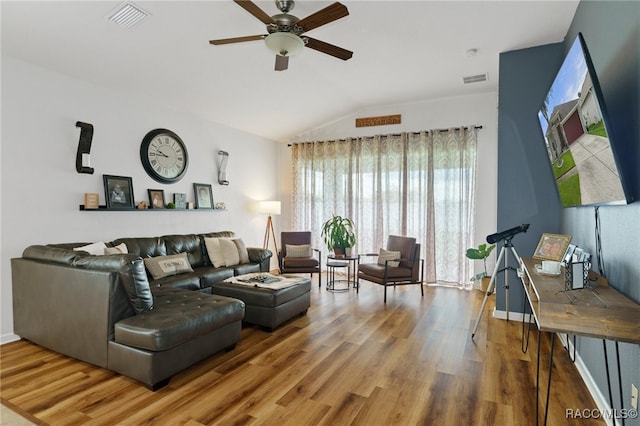 living room with ceiling fan, wood-type flooring, and lofted ceiling