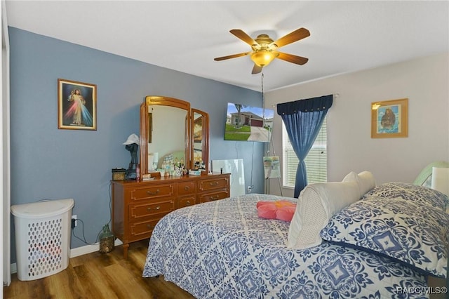 bedroom featuring dark hardwood / wood-style floors and ceiling fan