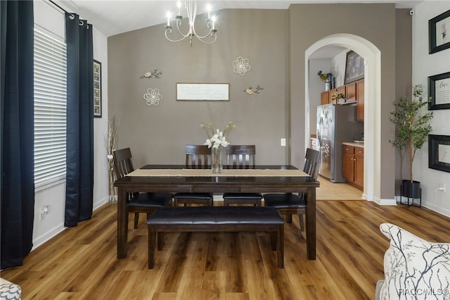 dining area featuring light hardwood / wood-style flooring and a notable chandelier