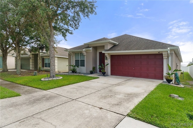 view of front of home featuring a front yard and a garage