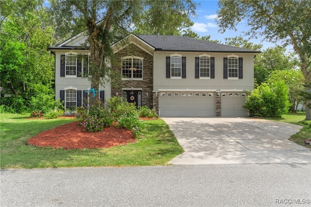 view of front of house featuring a garage and a front yard