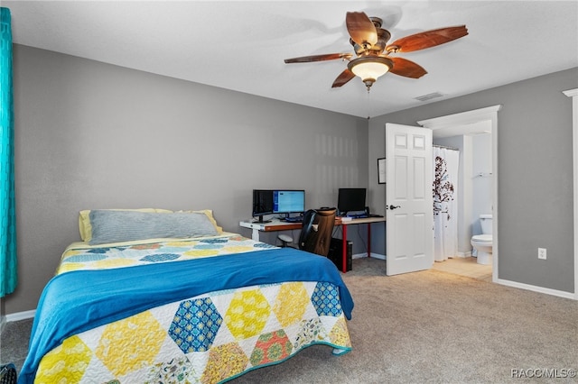 bedroom with light carpet, connected bathroom, and ceiling fan