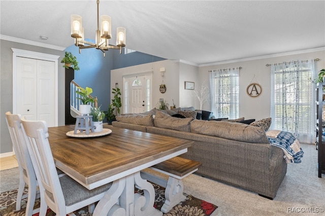 carpeted dining room featuring ornamental molding and an inviting chandelier