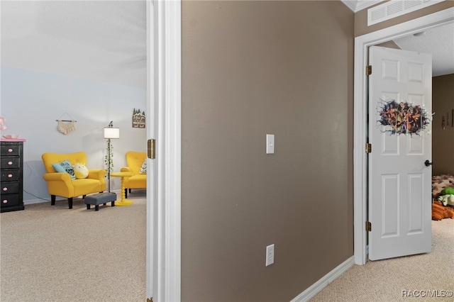 corridor with carpet and a textured ceiling