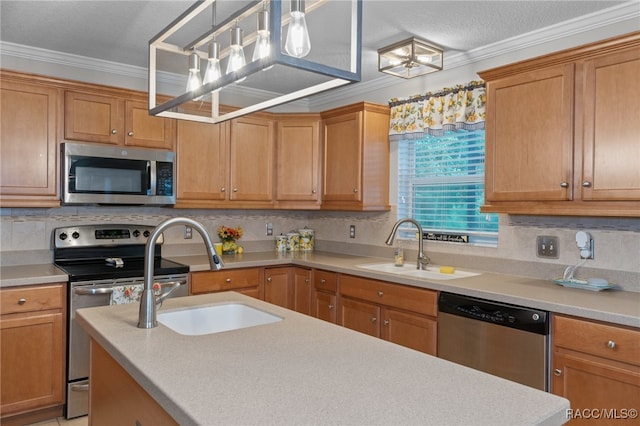 kitchen featuring decorative light fixtures, sink, crown molding, and appliances with stainless steel finishes