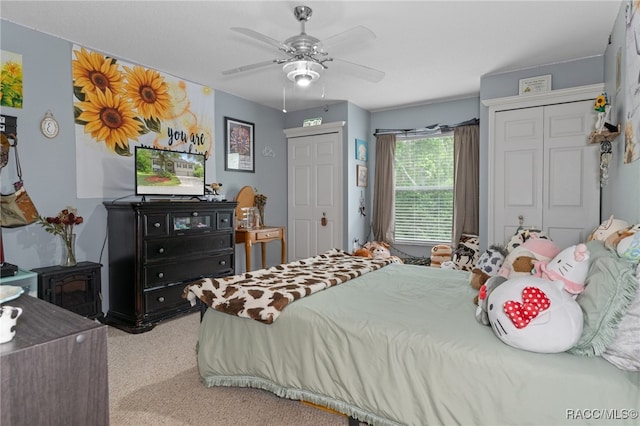 bedroom featuring ceiling fan and light colored carpet