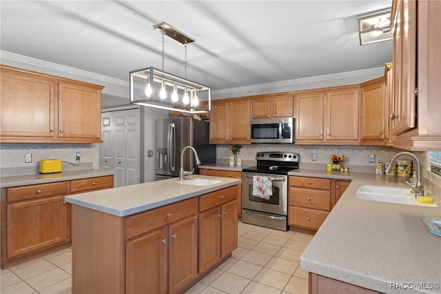 kitchen featuring sink, an island with sink, hanging light fixtures, and appliances with stainless steel finishes