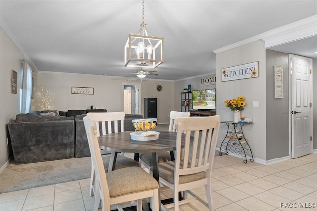 dining room featuring crown molding and light tile patterned flooring