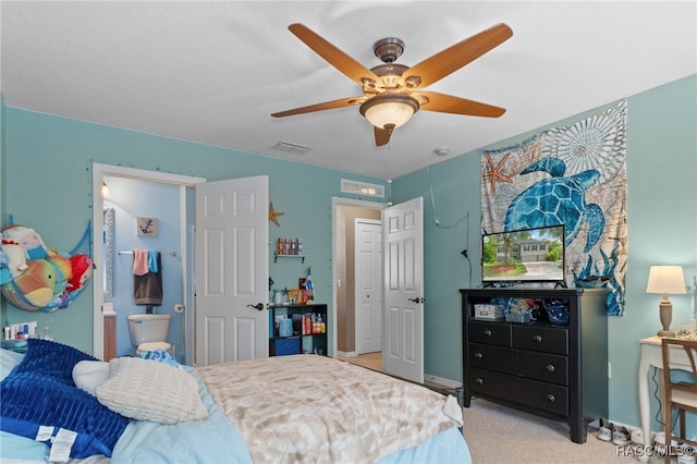 bedroom featuring ensuite bath, ceiling fan, and light carpet