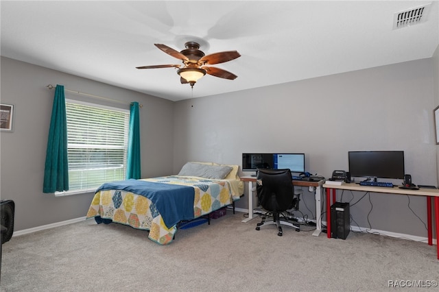 bedroom with ceiling fan and light colored carpet