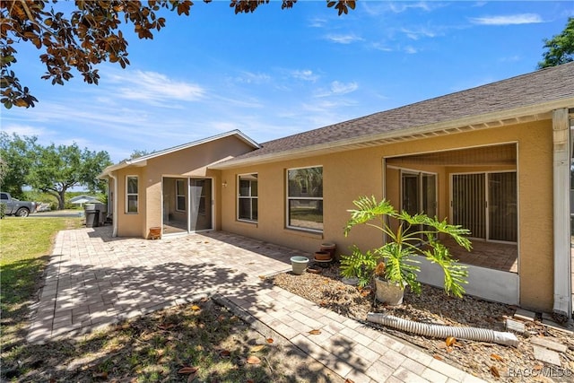 back of house featuring a patio area and stucco siding