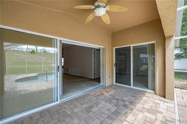 view of patio featuring a ceiling fan and an outdoor pool