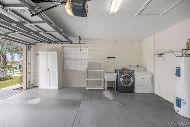 garage featuring water heater, concrete block wall, a garage door opener, and washer and clothes dryer