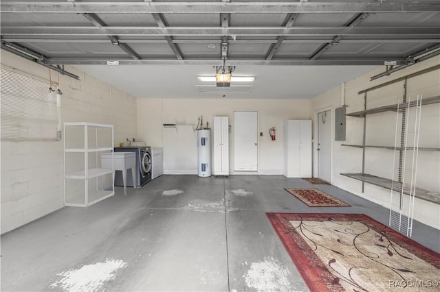 garage featuring washing machine and clothes dryer, electric panel, a garage door opener, and electric water heater