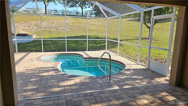 outdoor pool with glass enclosure, a yard, and a patio area