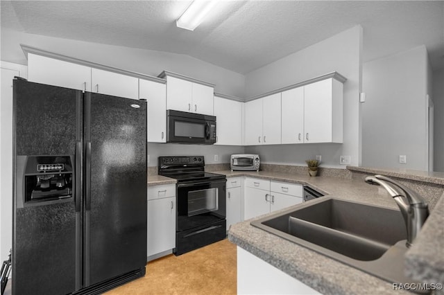 kitchen with a sink, light countertops, white cabinetry, vaulted ceiling, and black appliances