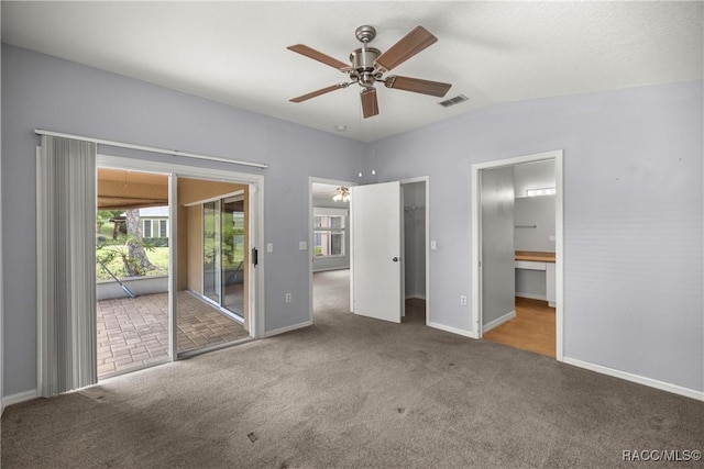 unfurnished bedroom with baseboards, access to outside, carpet, and visible vents