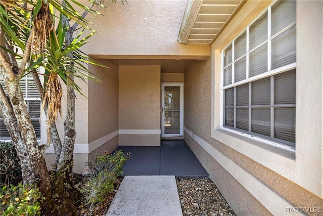 property entrance featuring stucco siding