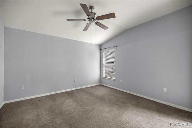 carpeted spare room featuring baseboards, a ceiling fan, and lofted ceiling