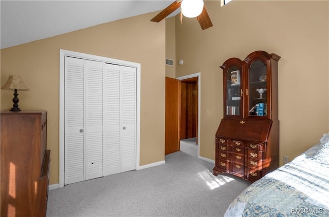 carpeted bedroom featuring ceiling fan, lofted ceiling, and a closet