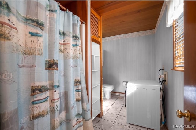 bathroom featuring wood ceiling, tile patterned floors, toilet, and washer / dryer