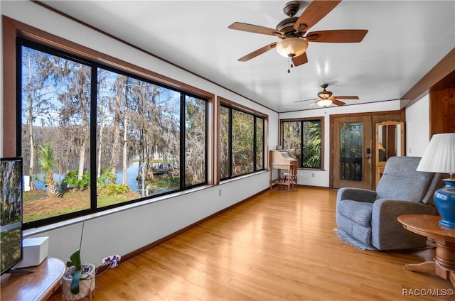 sunroom with a water view and a healthy amount of sunlight