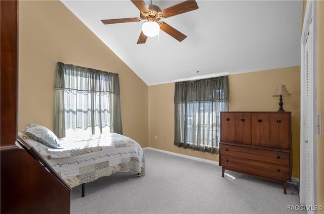 carpeted bedroom featuring lofted ceiling, a closet, and ceiling fan