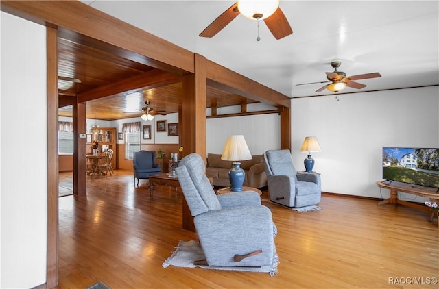 living room with hardwood / wood-style flooring and ceiling fan