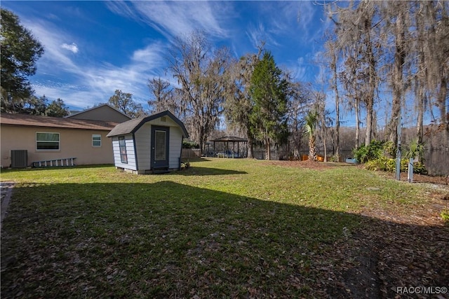 view of yard with a gazebo, central AC, and a shed