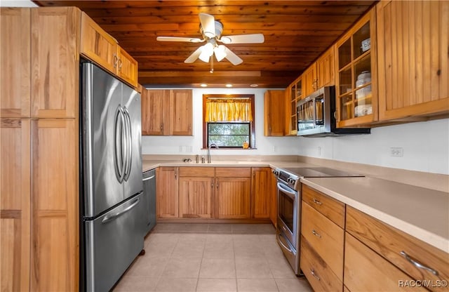 kitchen featuring light tile patterned floors, sink, ceiling fan, appliances with stainless steel finishes, and wooden ceiling