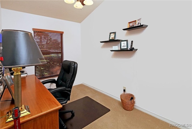 carpeted office space with vaulted ceiling