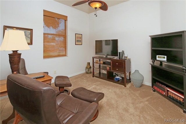 carpeted living room with ceiling fan