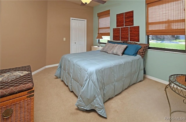 carpeted bedroom with a closet and ceiling fan