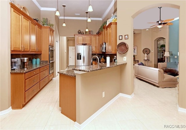 kitchen with ceiling fan, dark stone countertops, kitchen peninsula, decorative light fixtures, and appliances with stainless steel finishes