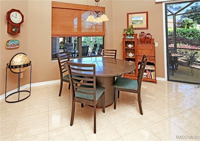 dining room featuring a notable chandelier and light tile patterned floors