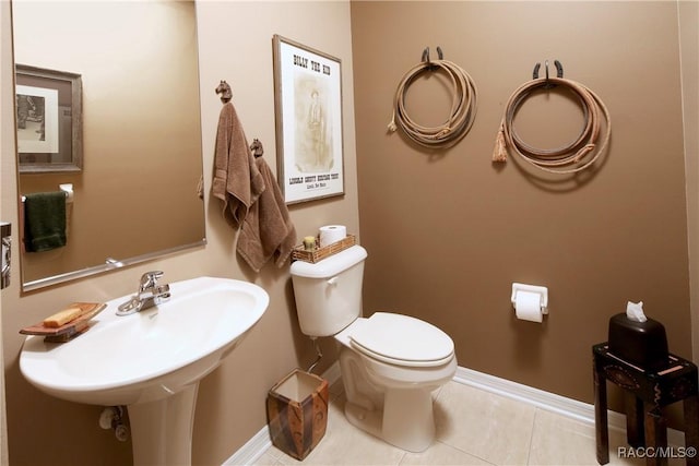 bathroom featuring tile patterned floors, sink, and toilet