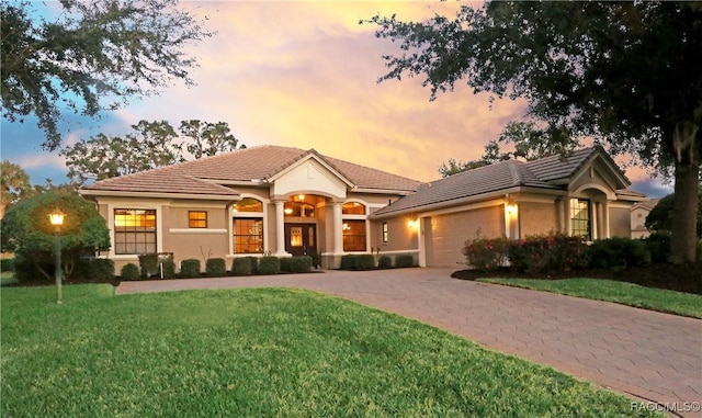 view of front of property with a lawn and a garage