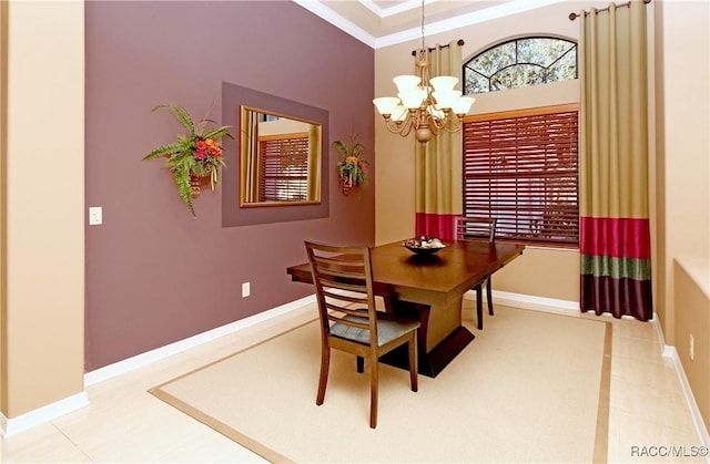 tiled dining room featuring crown molding and a chandelier