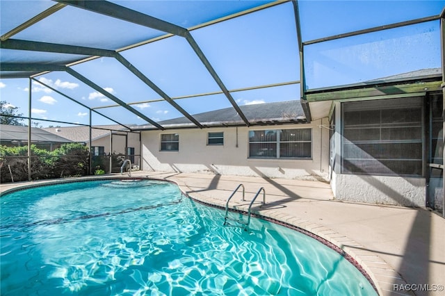 view of pool featuring a patio area and a lanai