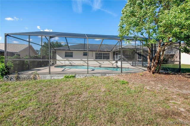 view of swimming pool featuring a lanai and a yard