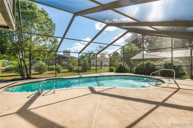 view of swimming pool with a lanai and a patio