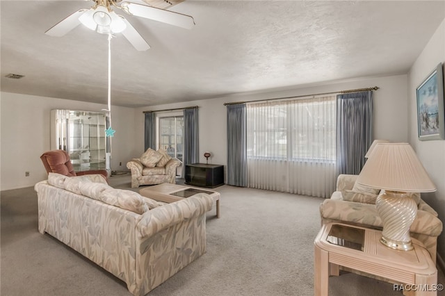 carpeted living room with ceiling fan