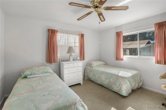 bedroom featuring multiple windows, ceiling fan, and light colored carpet