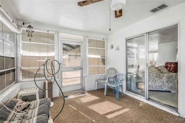 interior space featuring carpet and ceiling fan