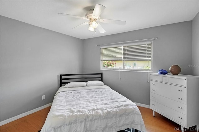 bedroom with ceiling fan and light hardwood / wood-style floors