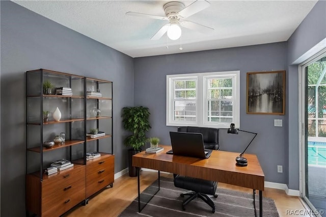 office area featuring ceiling fan, a healthy amount of sunlight, and a textured ceiling