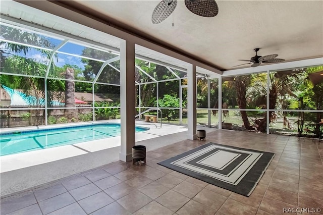 view of swimming pool featuring ceiling fan, a lanai, and a patio area